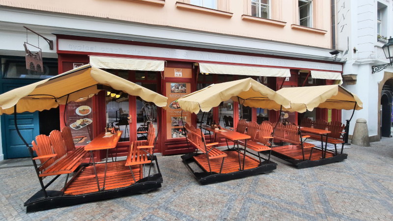 front of restaurant mustek in prague with swing seating