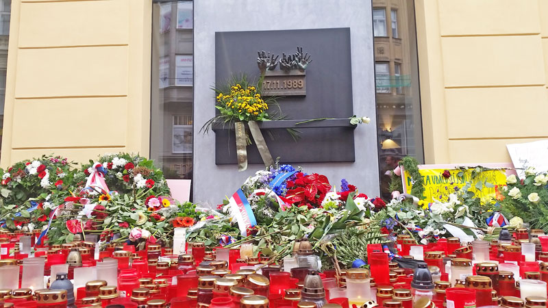 prague velvet revolution memorial plaque with flowers and candles