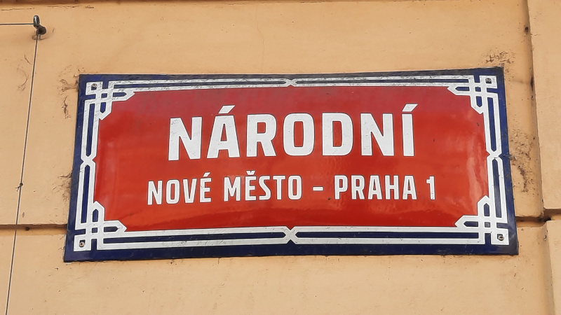 red and white new town street sign in prague called narodni or national street