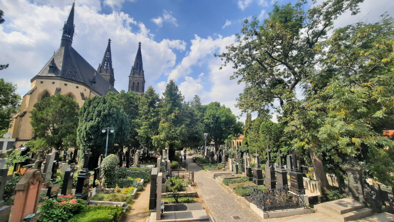 prague vysehrad cemetery scene with graves, trees and st peter and st paul church