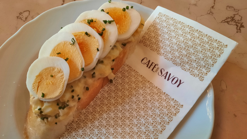 egg and chives open sandwich with prague cafe savoy napkin