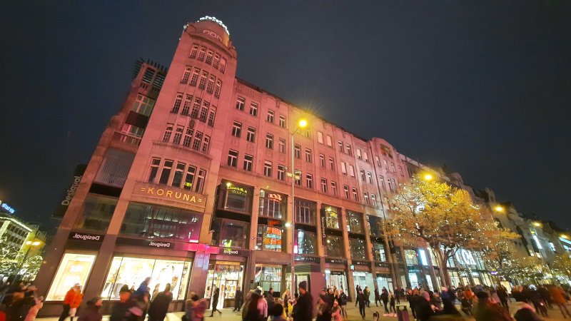 prague koruna palace at night with red tint