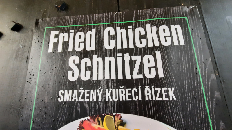 signage for fried chicken schnitzel with czech translation