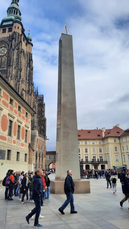 Prague castle obelisk in the third courtyard of the castle with the old deanery, st vitus cathedral and old royal palace