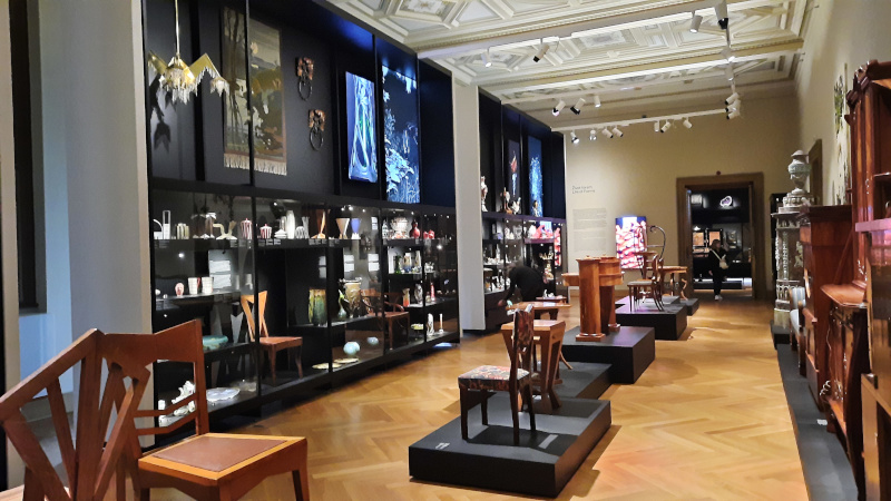 an exhibition hall of the prague museum of decorative arts with furniture and ceramics