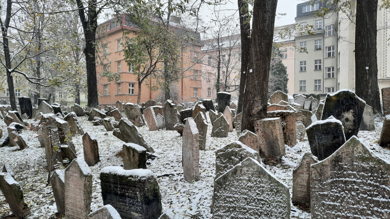 prague old jewish cemetery with snow on gravestones