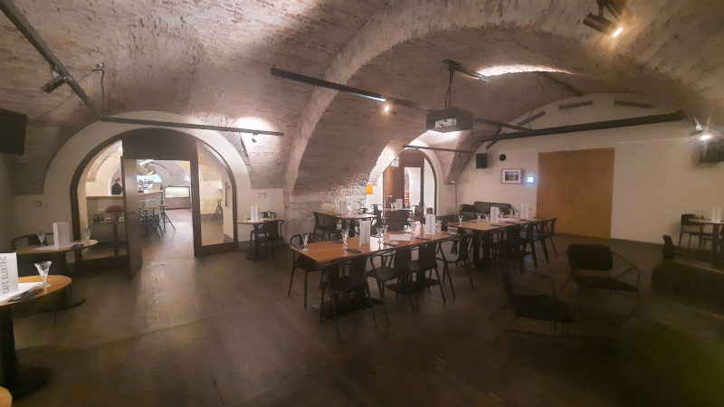 cellar cafe called cafe elektric in prague with tables and chairs