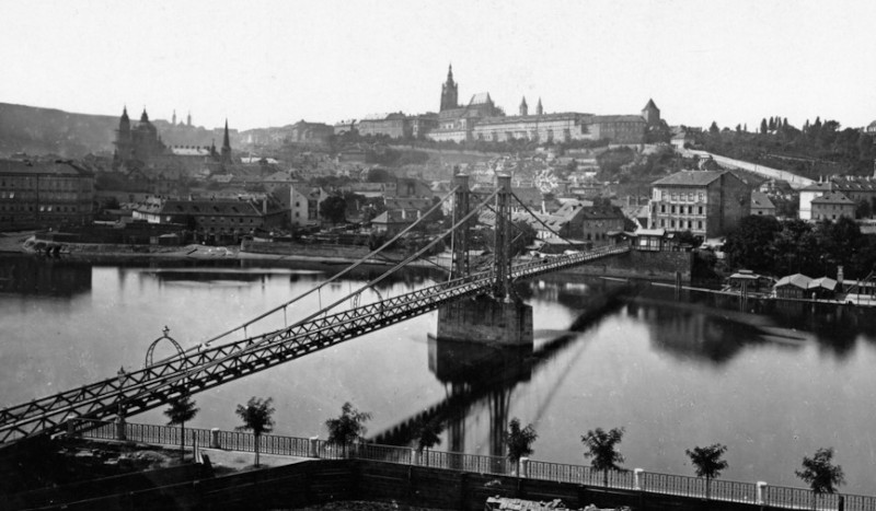 prague iron footbridge across the river vltava showing an incomplete ST Vitus Cathedral