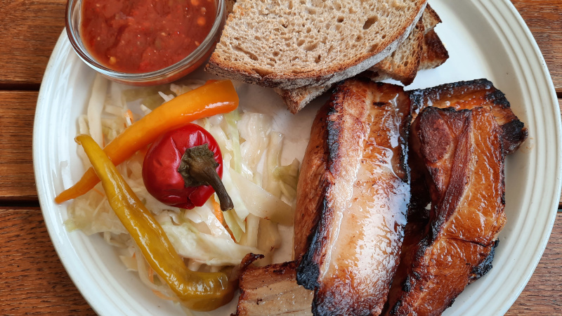 bucek pork belly served with toasted bread, pickled cabbage and peppers