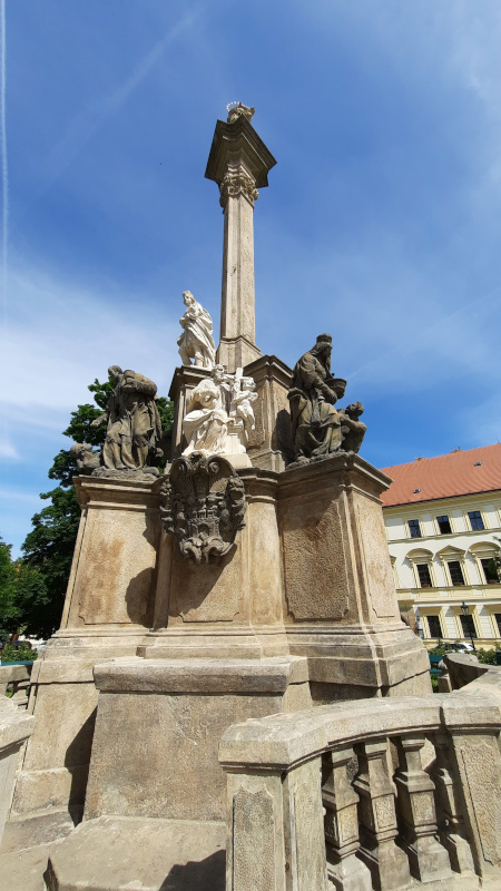 prague plague columns with a full length picture of the hradcany column in front of prague castle