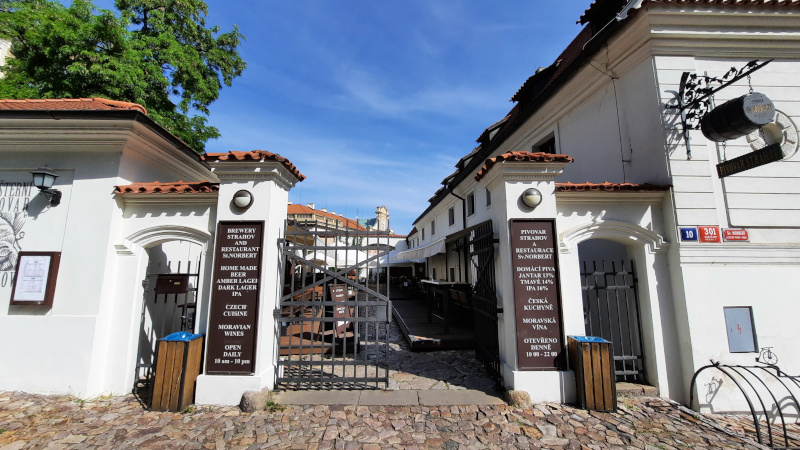 main entry to the strahov brewery in prague with cobble stones on the floor and iron gate