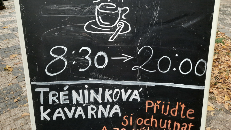 Blackboard showing opening times of prague cafe martin